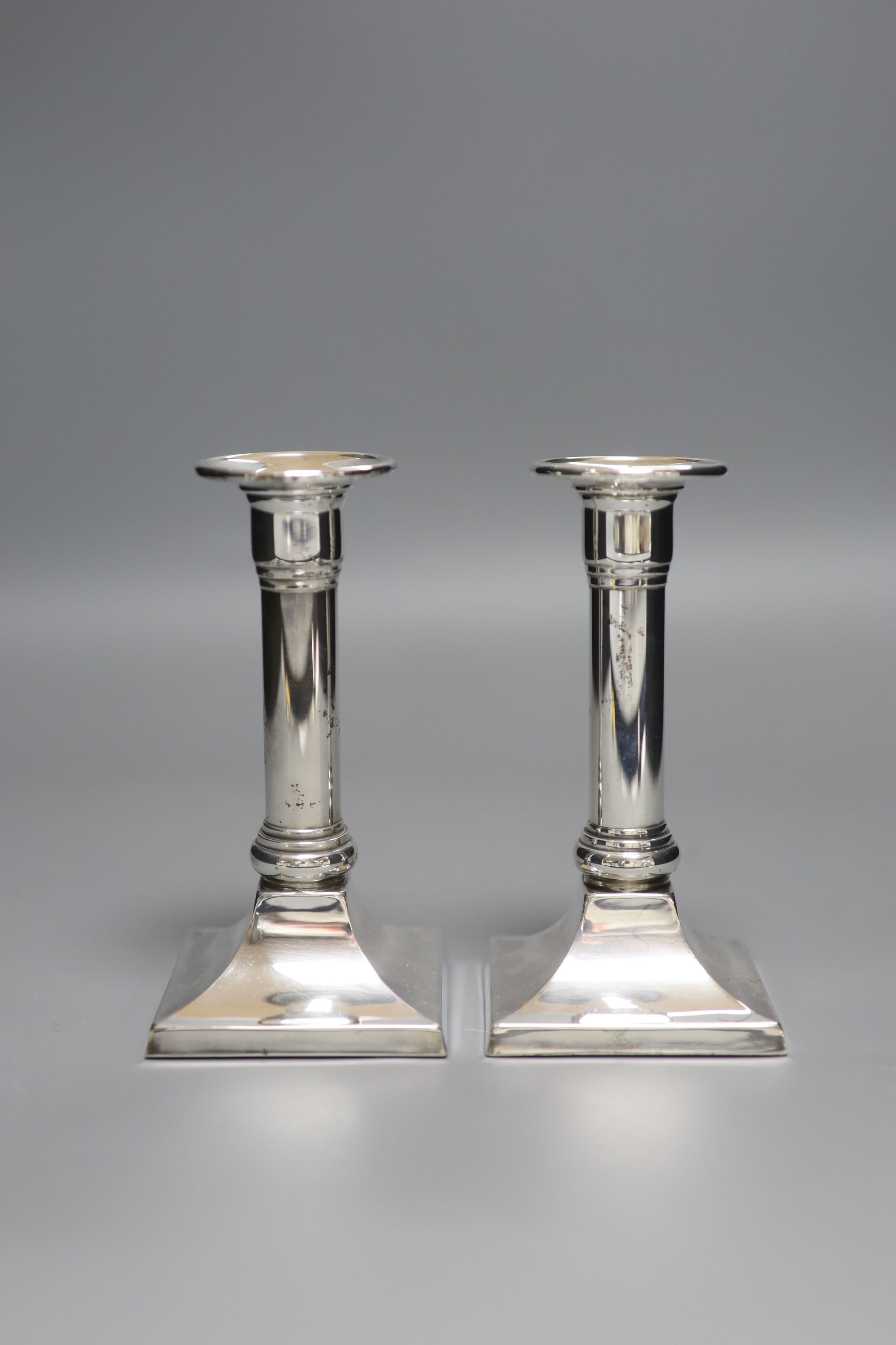 A pair of modern 925 sterling dwarf candlesticks, height 14.5cm, weighted.